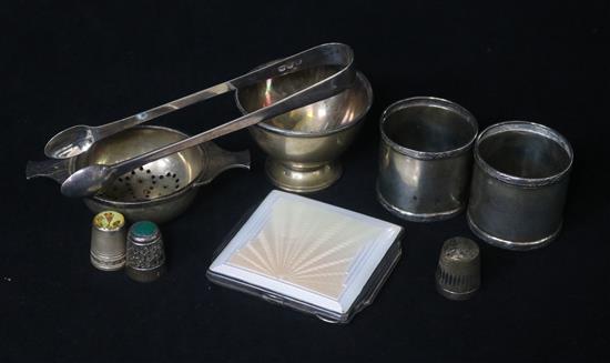 A small group of silver including Art Deco silver and enamel cigarette case, tea strainer and napkin rings.